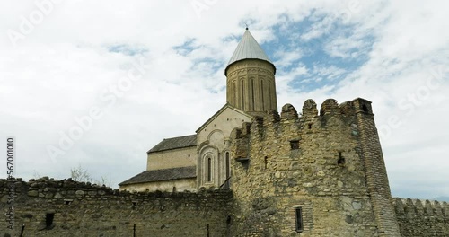 Kakhetian cathedral with fortress-style defensive walls from High Middle Ages. photo