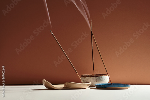 A set of burning incense for yoga or meditation. Minimalistic concept with warm colors photo