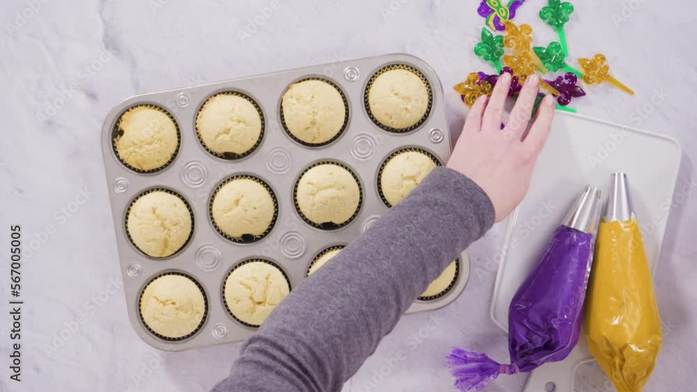 Flat lay. Step by step. Frosting vanilla cupcakes with Italian buttercream icing for Mardi Gras celebration.