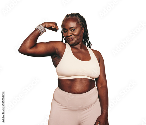 Foto Mature black woman flexing her bicep while standing against a transparent backgr
