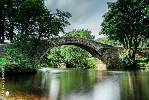 Bridge in the Yorkshire Dales with long exposure to produce out of focus blurred water