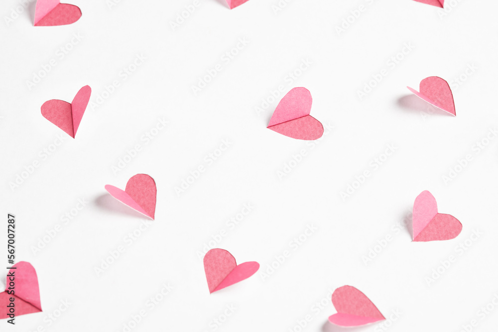 Pink hearts cut out from white paper. Festive background for valentine's day. Pink hearts cut out from white paper. Festive background for valentine's day.