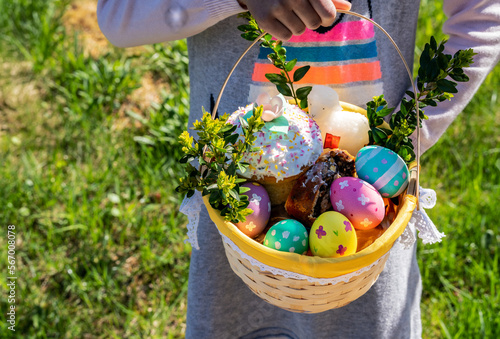 Girl with picnic easter basket on the grass	