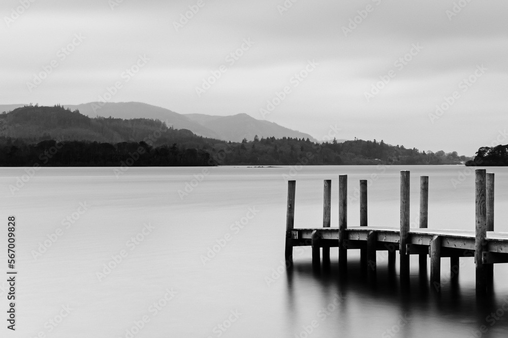 Naklejka premium Derwentwater Jetty near Keswick in the Lake District. Boat landing with still out of focus water. 