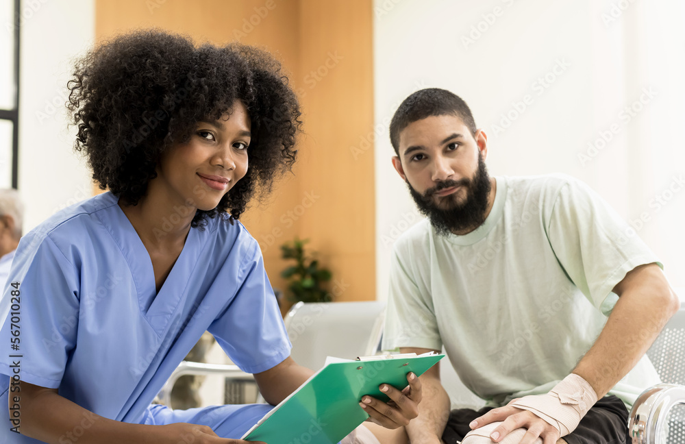 Obraz premium African American woman doctor in uniform with beard man patient in hospital, Hospital Concept
