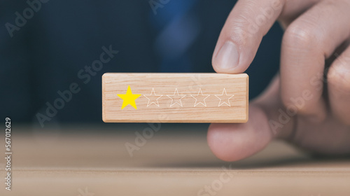 Customer review experience Dissatisfied Choosing 1 star review on wooden block