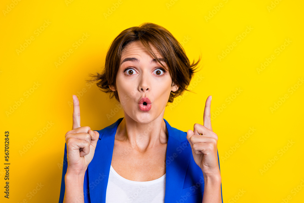 Photo of funny businesswoman wear blue jacket pouted lips crazy news direct fingers up opening cheap hotel prices isolated on yellow color background Photo of funny businesswoman wear blue jacket pouted lips crazy news direct fingers up opening cheap hotel prices isolated on yellow color background