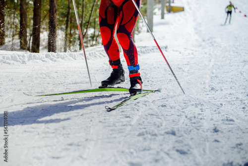 legs skier athlete with pole run uphill on ski race