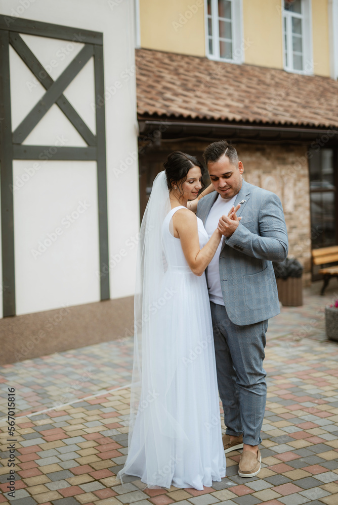 young couple the groom in and the bride on a walk