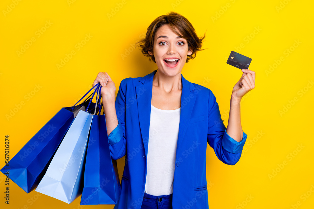 Photo of surprised promoter lady impressed low price shopping bags hold credit card isolated bright color background Photo of surprised promoter lady impressed low price shopping bags hold credit card isolated bright color background