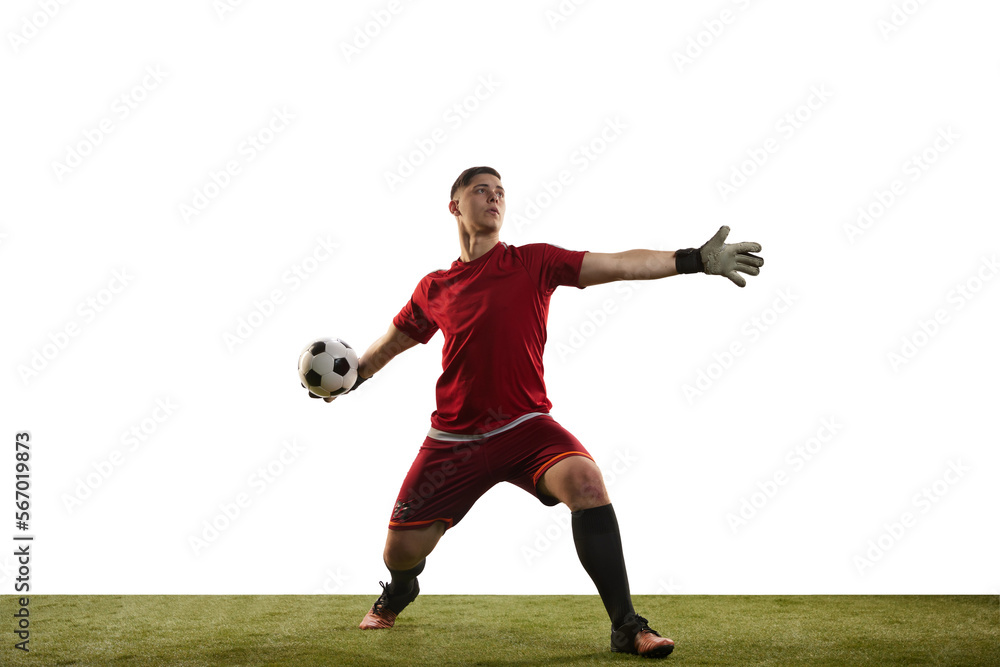 Young caucasian football player, male soccer goalkeeper wearing red football kit isolated over white background. Sport, hobby, success concept