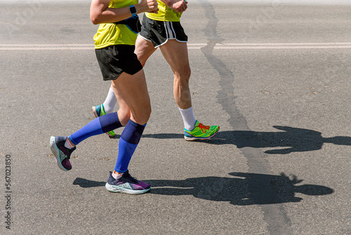 legs man and woman runners run marathon street © sports photos