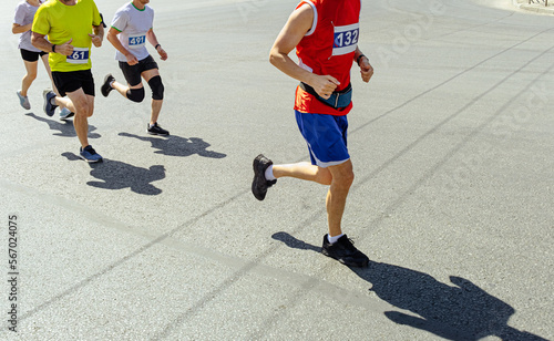 group runners run race on gray asphalt