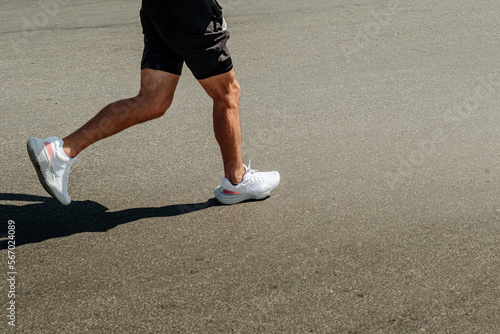 legs runner man running in white sneakers © sports photos