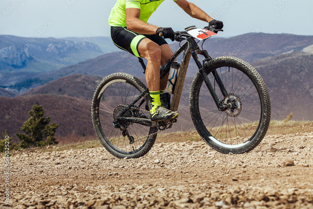Fototapeta premium athlete cyclist riding uphill on mountain bike