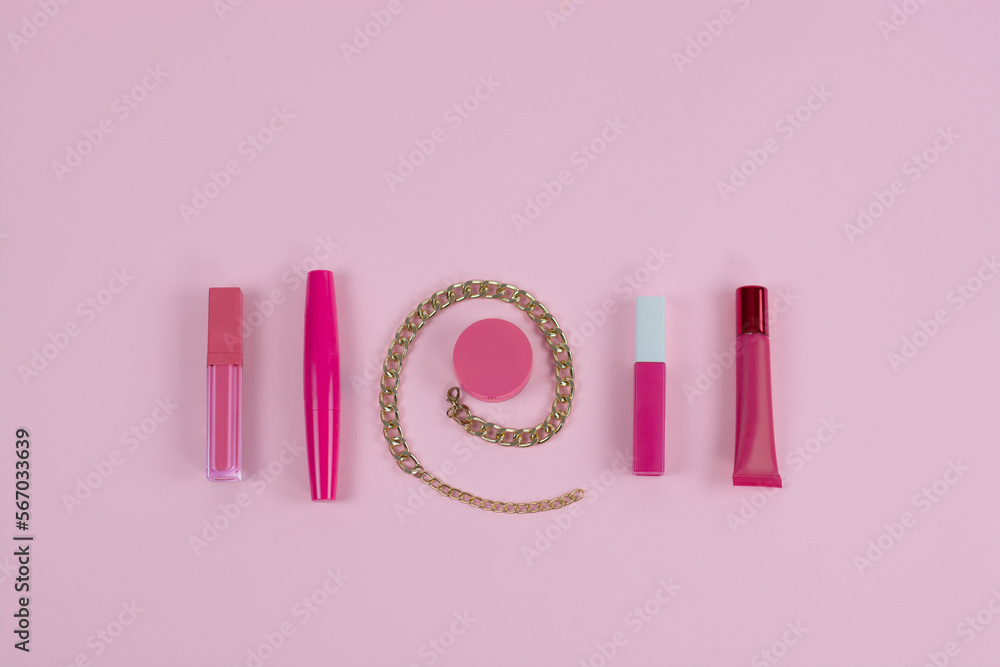 Flat lay beauty with lipsticks, beauty set with gold chain powder lip gloss on pink background Essential beauty items Beauty Frame Cosmetics Fashion