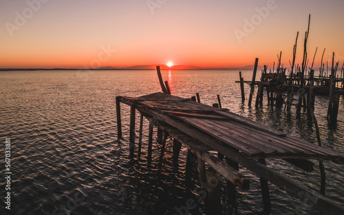 sunset on the palafitic pier of carrasqueira photo