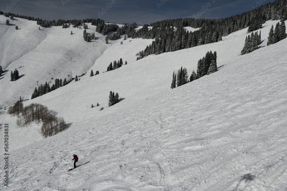Beautiful view of winter mountain slope covered with fresh snow and active skier quickly moving down. Vail Ski Resort, Colorado.