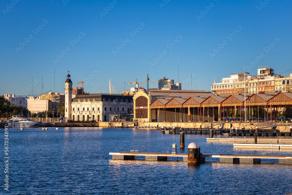 Obraz premium Landscape of the Port of Valencia with the clock tower at sunrise, Spain.