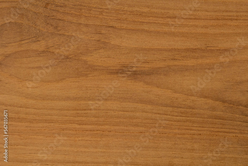 Golden texture of a cut old teak wood for background. Raw unfinished surface uneven are flaky from cutting and has a beautiful wood grain.
