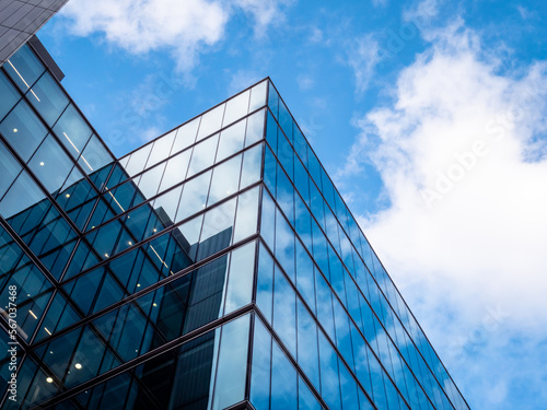 London UK - Close up of Business Financial district office headquarters within the modern skyscrapers. Blue clean modern glass wall with sky and cloud reflection. Capital city commercial district