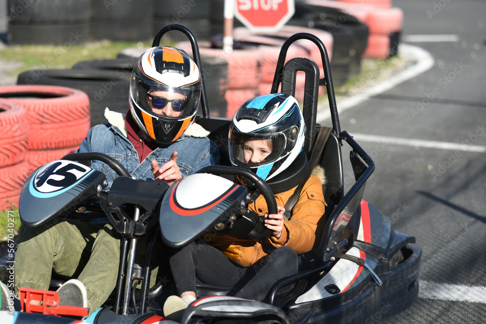 father and child driving in a kart