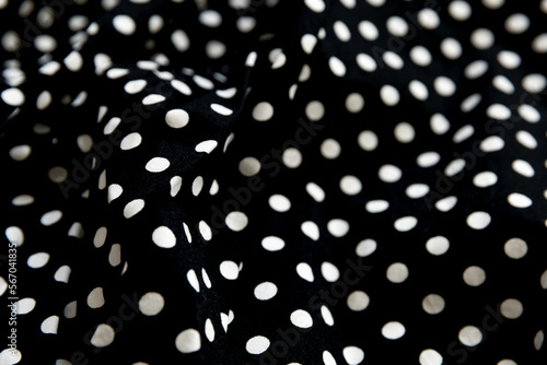 Polka dot patterned black and white fabric textile folded cloths as background