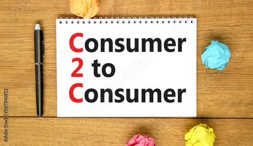 C2C consumer to consumer symbol. Concept words C2C consumer to consumer on white note on a beautiful wooden background. Business and C2C consumer to consumer concept. Copy space.
