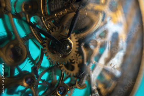 The view is close. Mechanism of a wristwatch. Gears, levers, springs and gems. Engraving and gold. old scratched glass. Concept of repair and service. Selective focus.