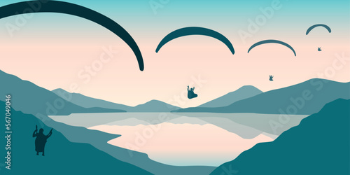 paragliding adventure flying with friends by the lake on mountain background at sunset