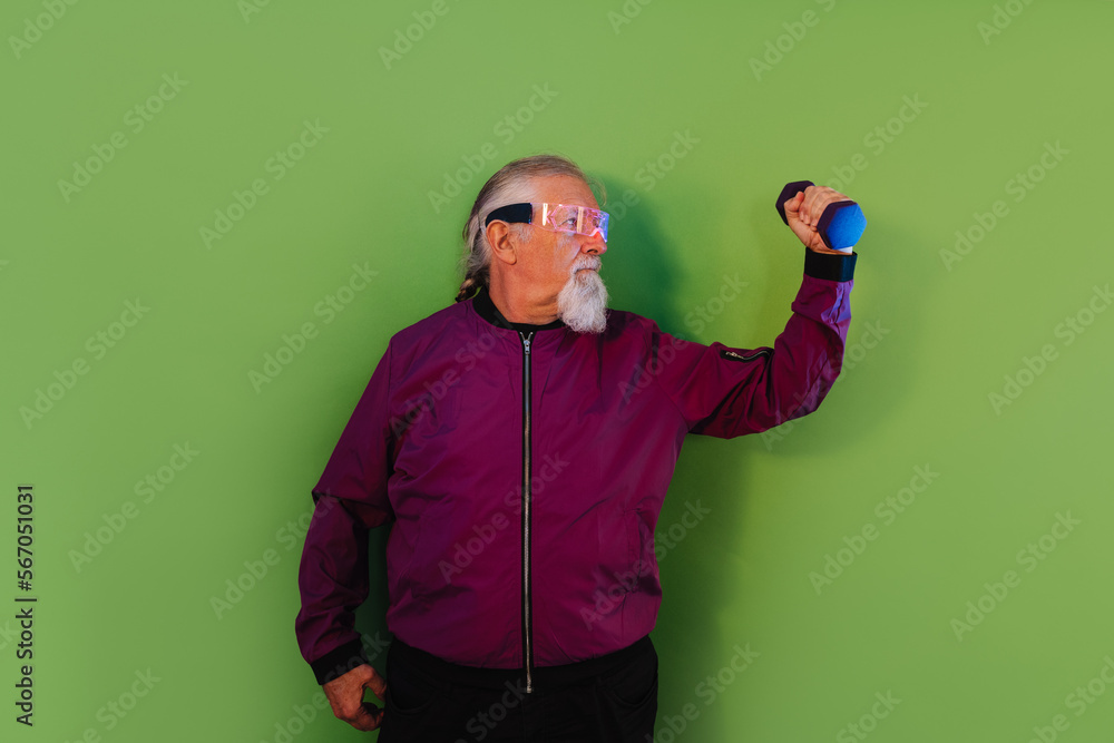 Confident senior man lifting dumbbell Confident senior man lifting dumbbell