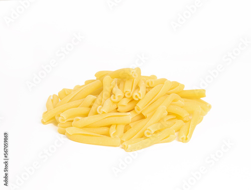 An image isolated close-up heap a raw pasta the italian food healthy on the white background with clipping path.