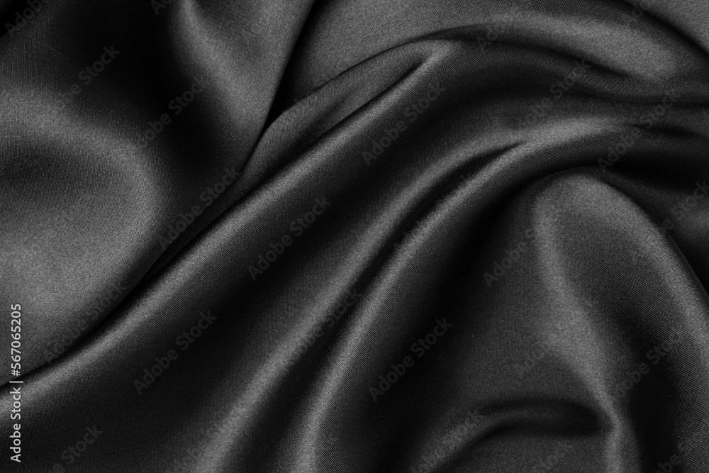 Fototapeta premium Black fabric texture background, wavy fabric slippery black color, luxury satin cloth texture.