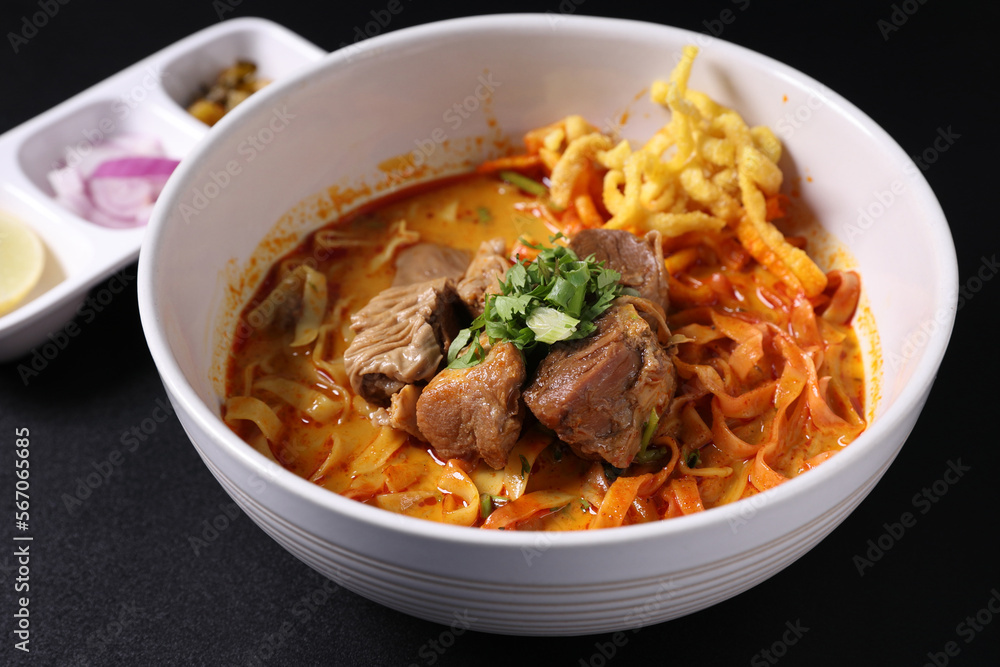 Khao Soi Thai Curry soup isolated in black background Khao Soi Thai Curry soup isolated in black background