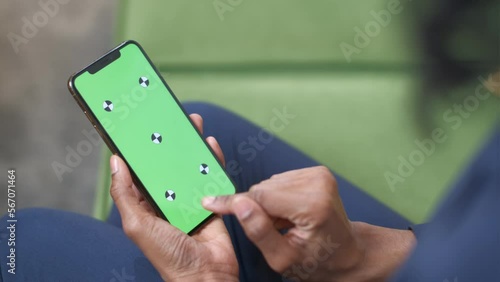 A black woman with a smartphone in her hand. Touch screen gestures: Tap, Swipe, Press, Drag, Pinch, Spread. Officework. The concept of a successful business woman, feminism. Close-up. Green screen