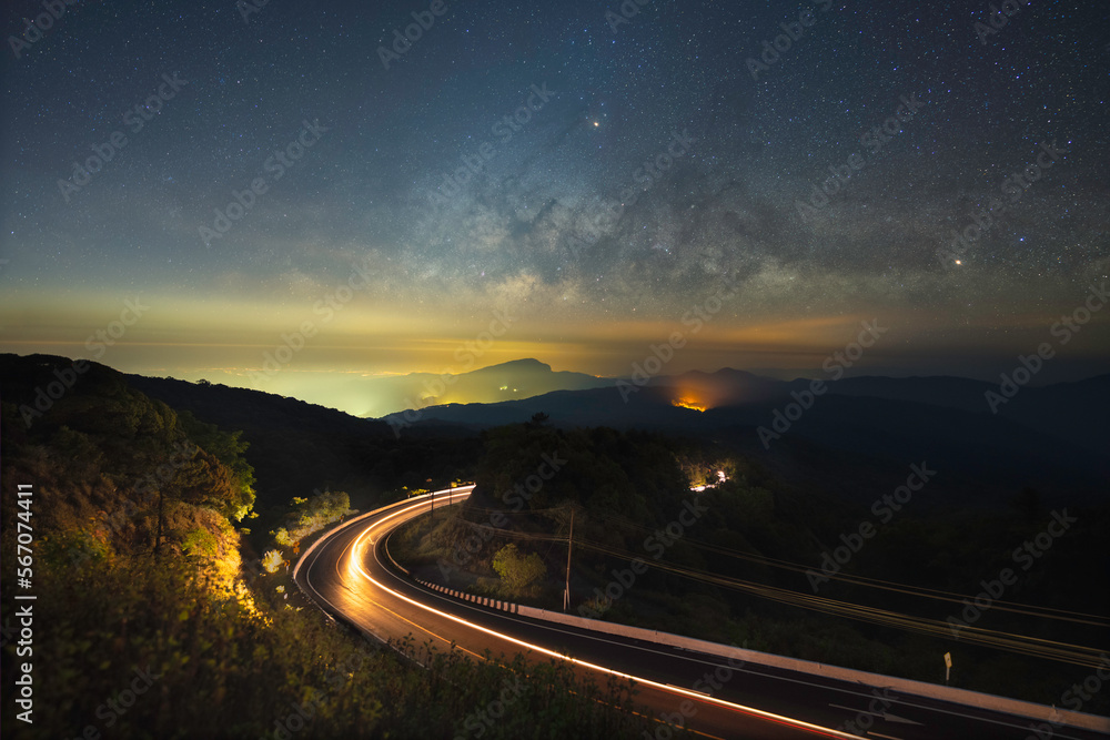 Milky way over the curve road and zodiacal light twilight color long exposure view. Popular travel Mountain Doi Inthanon Road km41 Chiang Mai province in Thailand.