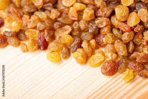 Close up of raisin on wooden table. Fresh tasty raisins on the table