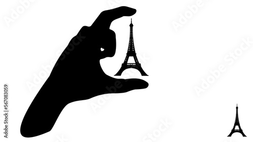 Hand hold between fingers Eifel tower in Paris, silhouette