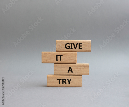 Give it a try symbol. Concept words Give it a try on wooden blocks. Beautiful grey background. Business and Give it a try concept. Copy space.