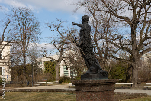 Neptune statue against the background of blue sky and clouds, Ujazdowski Park, Warsaw, Poland, 