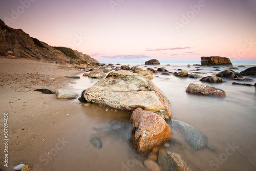 Close-up of rocks at beach during sunset photo