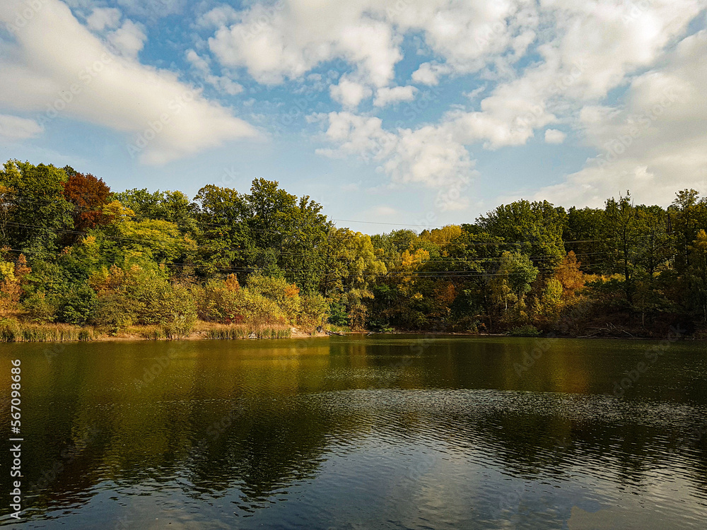 calm river near autumn forest at sunset calm river near autumn forest at sunset