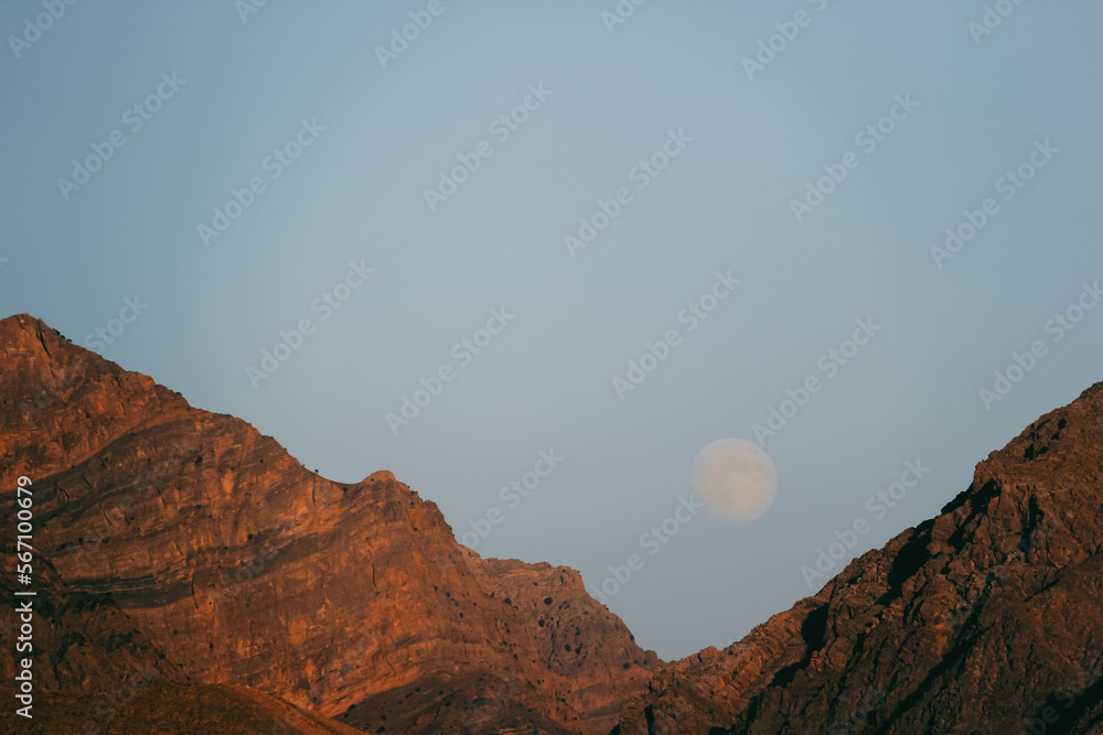 Afghanistan landscape, a mountain with a full moon in the background