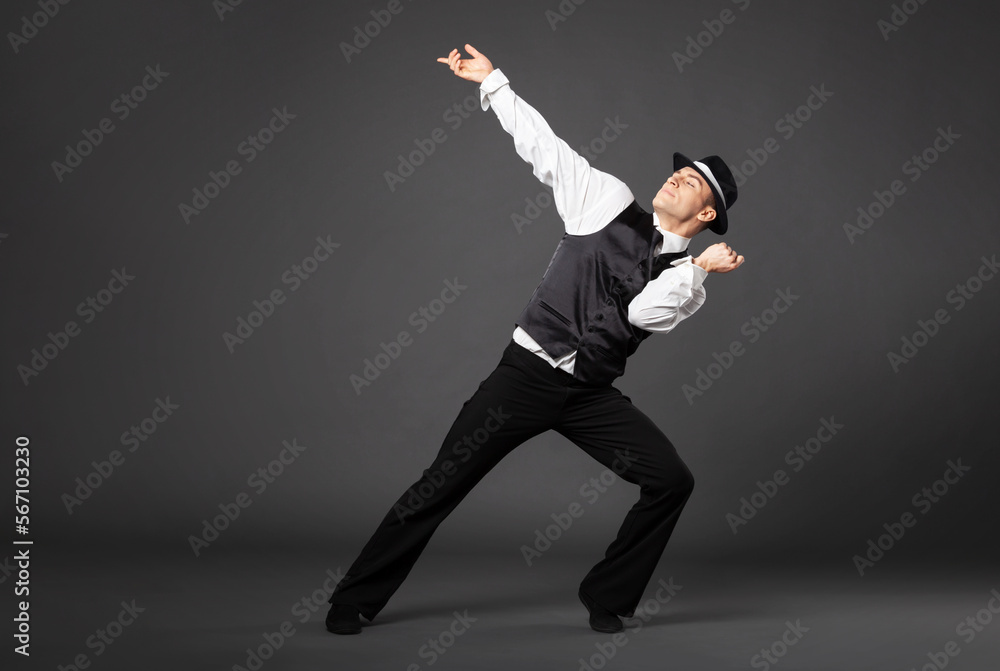 Confident young man dancing in gangster style suite. Confident young man dancing in gangster style suite.