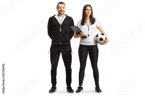 Full length portrait of a male and female football coaches posing