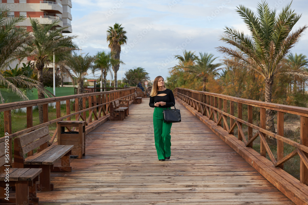 Woman walking on a wooden footbridge
