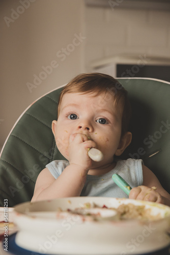Baby boy eating food, baby-led weaning 