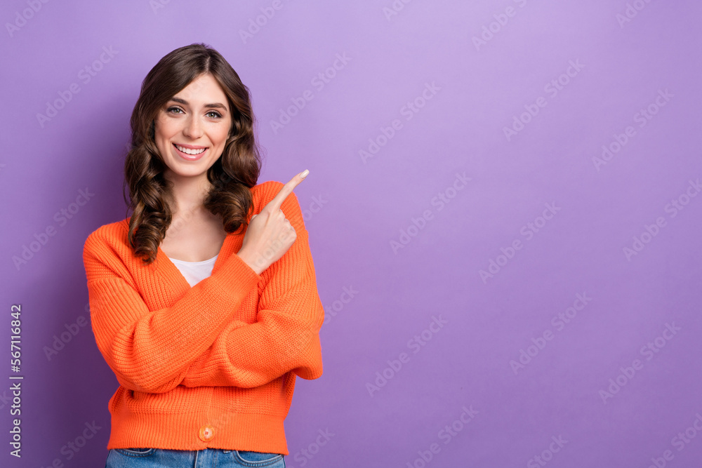Photo of positive nice lady toothy smile indicate finger empty space isolated on violet color background Photo of positive nice lady toothy smile indicate finger empty space isolated on violet color background