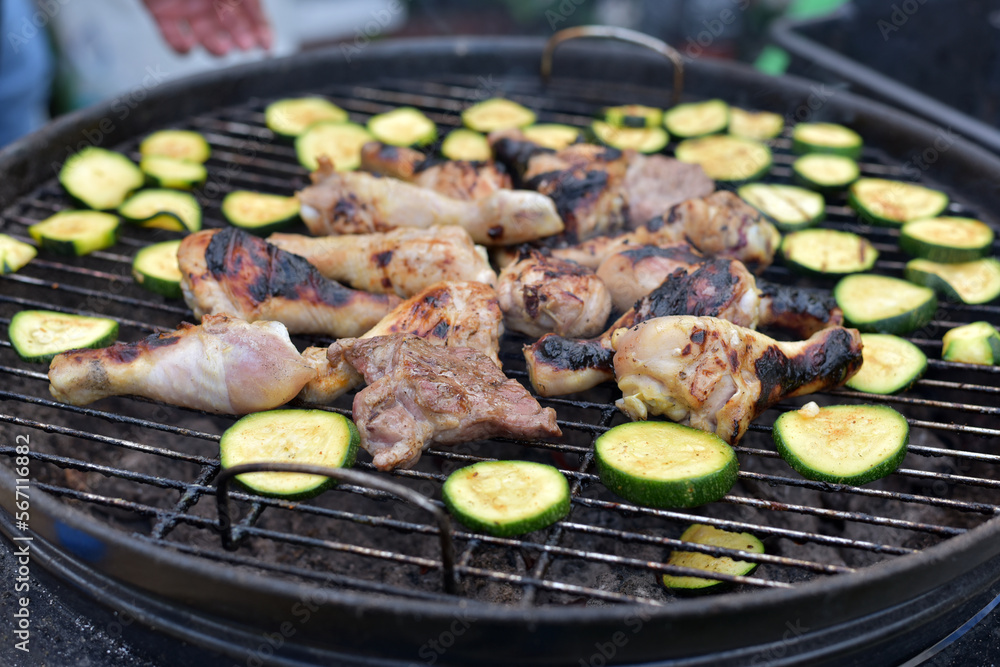 The vegetables are grilled. Meat on the grill