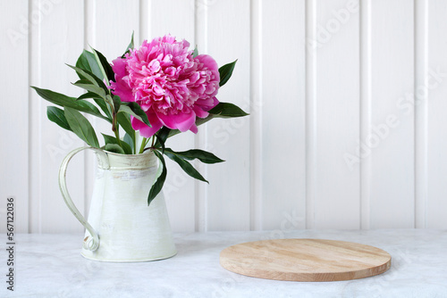 pink peony and cutting board on the table  place for your object or text.